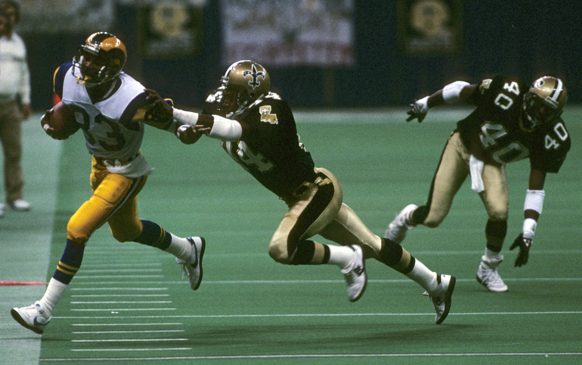Flipper Anderson makes a catch before going out of bounds against Saints defenders Dave Waymer and Robert Massey